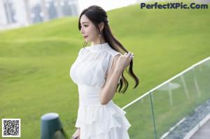 A woman in white stockings is sitting on a table.