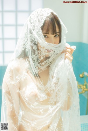 A woman in a white lingerie standing in a bathroom.