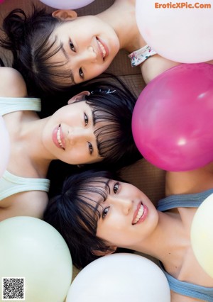 A group of three young women in bikinis posing for a magazine cover.