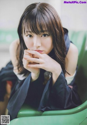A magazine with a picture of a woman with long black hair.
