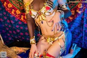 A woman in a costume sitting on the floor.