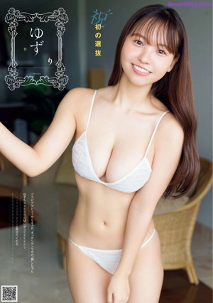 A woman in a red bikini standing on a beach.