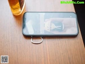 A woman sitting at a table talking on a cell phone.