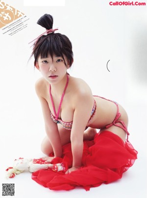 A woman in a red lingerie with a veil over her head.