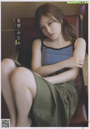 A woman sitting on top of a wooden table.