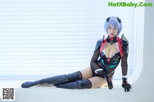 A woman with blue hair wearing a black and red outfit.