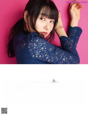 A woman in a red sweater posing for a picture.