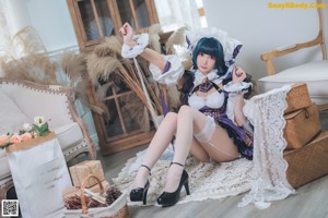 A woman dressed in a maid outfit posing for a picture.